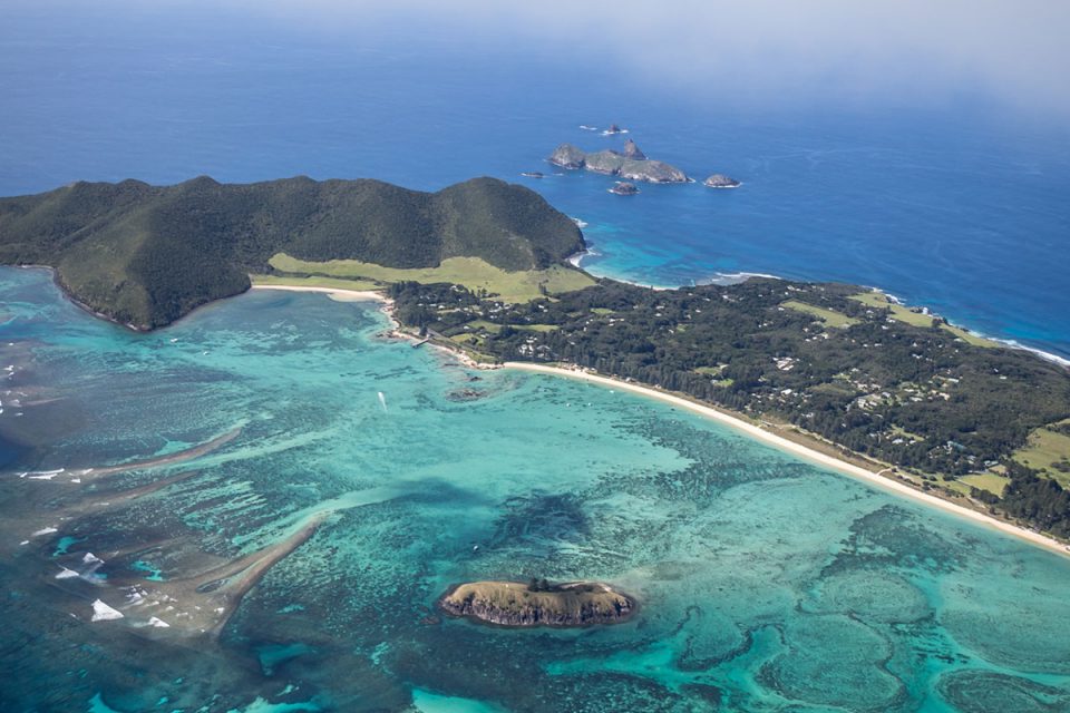 Take in stunning views as you fly over Lord Howe Island on arrival.